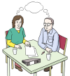 Zwei Menschen sitzen an einem Tisch und arbeiten gemeinsam